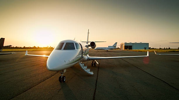 imageye___-_imgi_4_luxury-private-jet-with-personal-staircase-lowered-parked-on-airport-tarmac-at-sunset